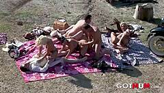 Blonde milf in cowboy role-play gets facial during outdoor orgy