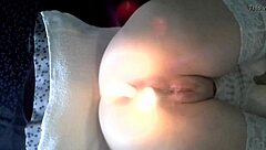 extreme scene with two candles in her body.