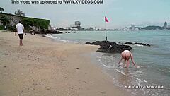 White transparent swimsuit flashes wet body on public beach