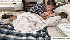 Couple shares cozy bed moment.