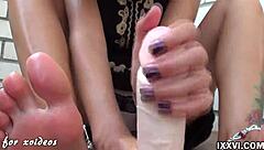 Hey, watch this teen babe give a footjob and handjob with a big dildo at home.