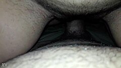 Beautiful housewife enjoying a cold glass of milk while sitting on her stool