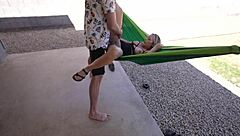 amateur couple relaxes in outdoor hammock