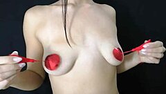 Young girl plays with her natural tits using nipple stickers.