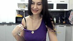 Mature brunette strips in the kitchen and enjoys some fun