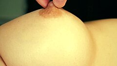 Watch this babe suck and massage her big tits close up