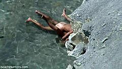 on the beach, an amateur couple engages in passionate sex under the sun