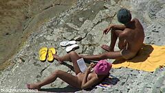 on the beach, an amateur couple engages in passionate sex under the sun