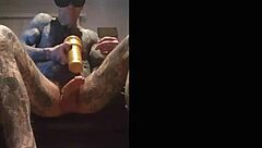 Tattooed guy strokes cock in fleshlight solo