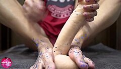 Watch this babe give a sensual footjob to a rubber cock.