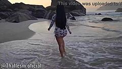 Tattooed latina sits on monster cock at beach