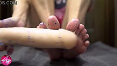Watch this babe give a sensual footjob to a rubber cock.