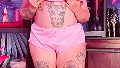 Teasing in silk pajamas with huge natural tits.