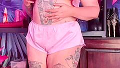 Teasing in silk pajamas with huge natural tits.