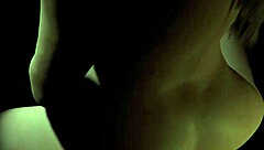 Beautiful curvy plum girl rides dildo in the dark, showing big tits and cute face.