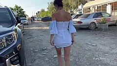 Two girls tease in public, flashing pussies without panties, small tits bouncing outdoors.