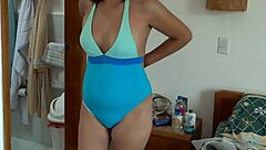 Beautiful 59-year-old woman teases in bikini on the beach, flashing natural tits in this great compilation