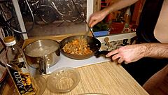 Naked gay chef cooks rice noodle with chicken and vegetables