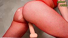 Hot milf in red fishnets rides dildo sensually, fingering her slutty pussy alone