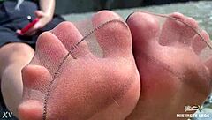 Goddess In Tan Nylons Shows Cute Nylon Soles And Toes On The Riverside