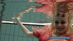 Katya feels free in red dress at pool.