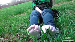 goddess feet in cute white socks on spring grass field 🌸