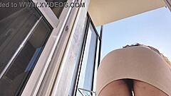 Hot Woman Teases On Balcony Without Panties, Showing Off Her Assets