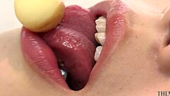 kitchen babe licks candy with naughty look