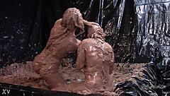Who wins this glam mud wrestling match?