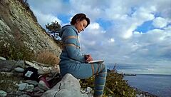 Sofi feels relaxed reading her book by the sea in POV