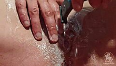 Woman in Bathroom Trims Her Wet Pussy Lips and Clit with Tattoo Visible