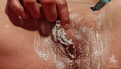 Woman in Bathroom Trims Her Wet Pussy Lips and Clit with Tattoo Visible