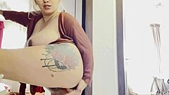 A blonde with big breasts is indulging in solo play