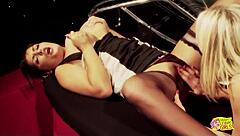 a blonde and a brunette with huge tits smoke cigarettes together