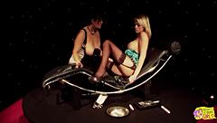 a blonde and a brunette with huge tits smoke cigarettes together