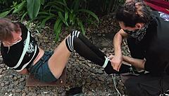 blonde teen beauty gets tangled up in park bondage