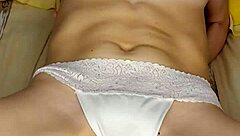 A girl in beautiful white lingerie caresses herself and fucks herself with a big pink dildo