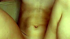 A girl in beautiful white lingerie caresses herself and fucks herself with a big pink dildo