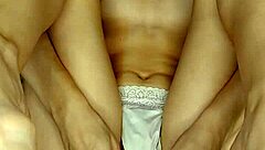 A girl in beautiful white lingerie caresses herself and fucks herself with a big pink dildo