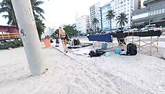 Sexy milf blonde flashes in mini short on Copacabana beach with guys staring