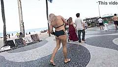 Sexy milf blonde flashes in mini short on Copacabana beach with guys staring