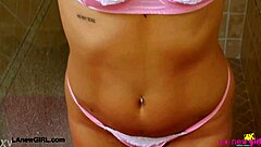 mesmerizing blonde model contrasts her petite body in a sensual shower