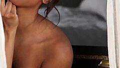 Hungarian ebony babe Amina Malakona strips to show her smooth shaved black pussy