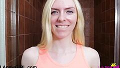 Blonde beauty enjoys a relaxing shower in a peaceful setting with natural light