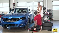 Intriguing dame with big boobs licks anus in car repair shop