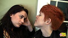 Redhead lesbian uses strap on to fuck brunette friend with small tits after coming home