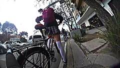 Exhibiting miniskirt upskirt through city streets with pigtails and socks