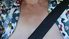 Hey, check out my naughty housewife flashing her tits in this homemade car selfie!