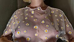 Hey, check out this blonde beauty with huge tits getting wet in a see-through top during her steamy shower