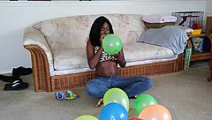 Bold French Ebony Woman Inflates Balloons with Intense Energy and Flair